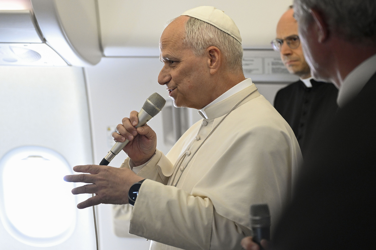  Pope Leo XIV speaks aboard the papal plane flying to Rome on April 23, 2026. 
