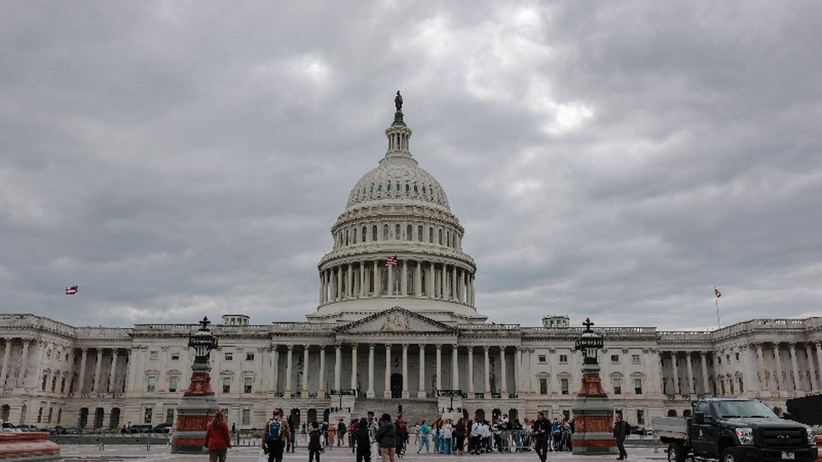 People stand near the U.S. Capitol building on a cloudy day in Washington, D.C., U.S., May 14, 2026. REUTERS/Kylie Cooper