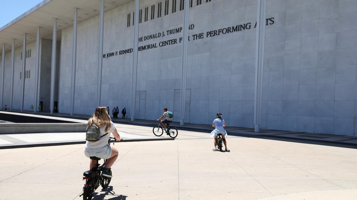 Cyclists ride by the John F. Kennedy Memorial Center for the Performing Arts, renamed The Donald J. Trump and The John F. Kennedy Memorial Center for the Performing Arts by the Trump administration, after a federal judge ordered that President Trump’s name be removed from the building, in Washington, D.C., U.S., June 3, 2026. REUTERS/Kevin Lamarque