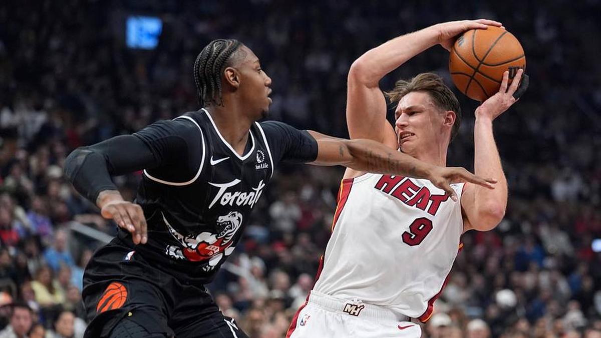  Apr 9, 2026; Toronto, Ontario, CAN; Toronto Raptors forward RJ Barrett (9) defends against Miami Heat forward Pelle Larsson (9) during the first half at Scotiabank Arena. Mandatory Credit: John E. Sokolowski-Imagn Images | John E. Sokolowski-Imagn Images 