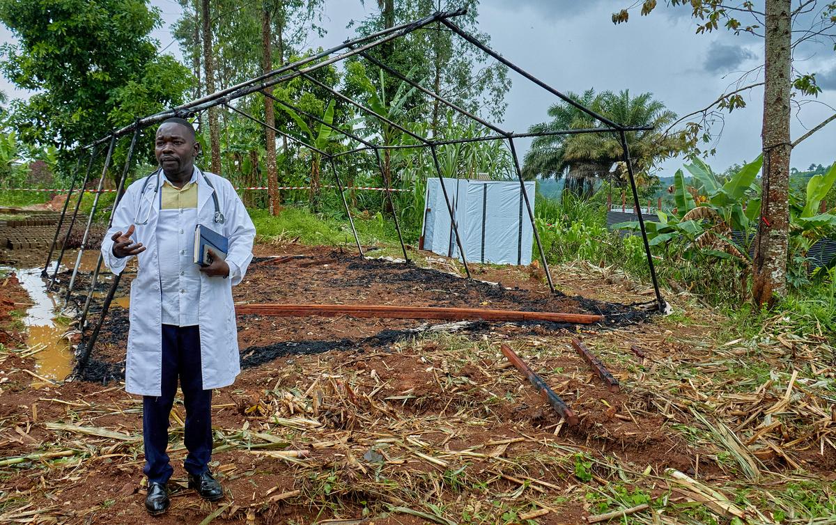 Medical Director of Mungwalu General Hospital Richard Lokudu speaks to Reuters next to the burned remains of a destroyed Médecins Sans Frontières (MSF) emergency isolation tent at the Mongbwalu General Referral Hospital as aid agencies intensify efforts to contain an Ebola outbreak caused by the Bundibugyo virus in Mongbwalu, Djugu Territory of Ituri province, Democratic Republic of Congo, May 23, 2026. REUTERS/Gradel Muyisa Mumbere