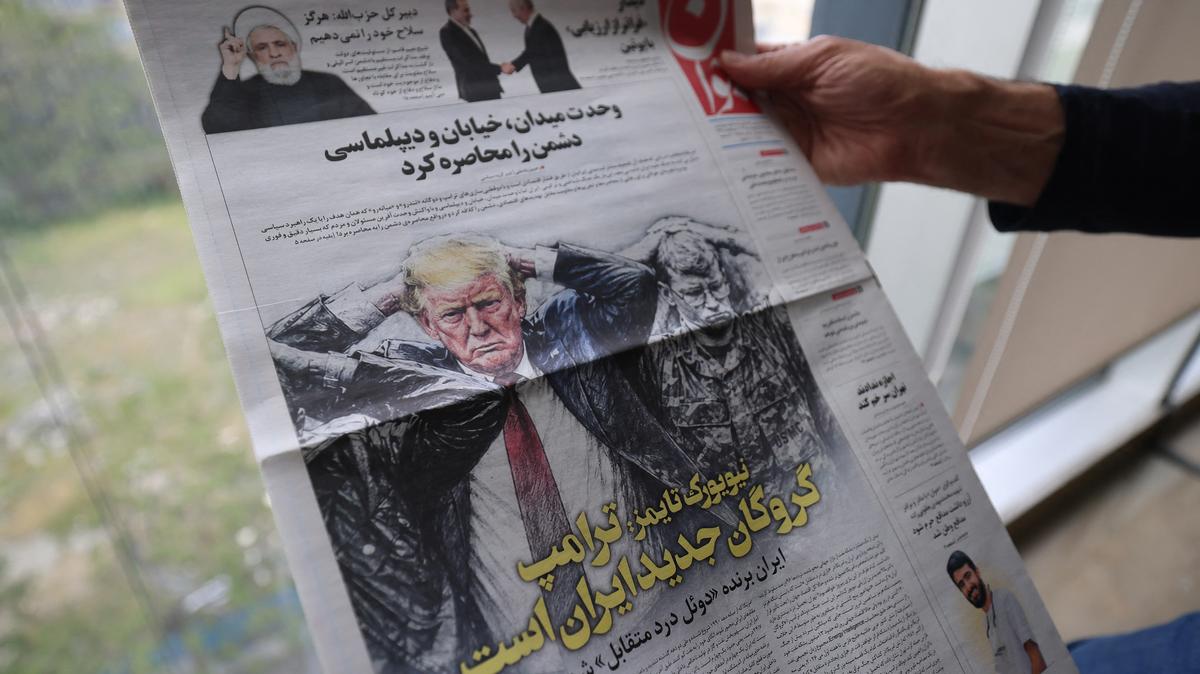 A person displays the front page of the Persian-language Javan newspaper, bearing the headline "Trump is Iran's new hostage," alongside a cartoon depicting U.S. President Donald Trump as a hostage, in Tehran on April 28, 2026. The White House said on April 27 it was examining Iran's latest proposal to unblock the Strait of Hormuz, two months after a U.S. and Israeli offensive sent shockwaves through the global economy. (Atta Kenare/AFP/Getty Images/TNS)
