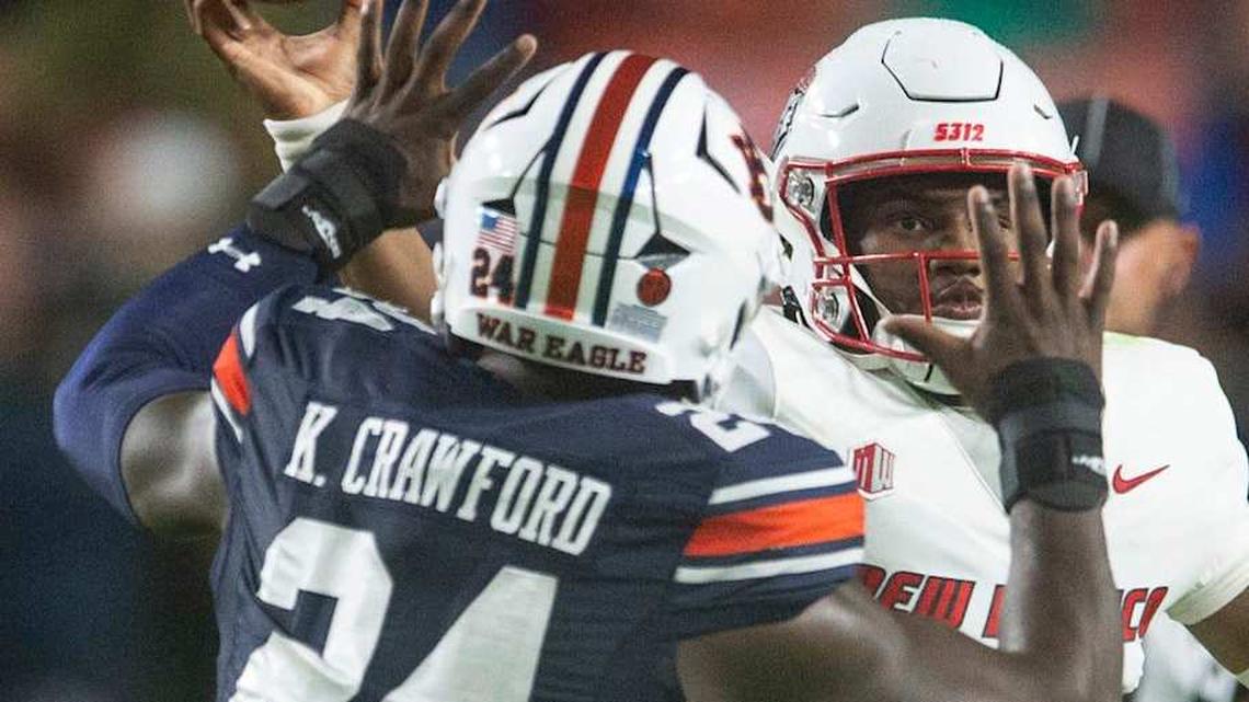  New Mexico Lobos quarterback Devon Dampier (4) throws the ball under pressure from Auburn Tigers defensive lineman Keyron Crawford (24) as Auburn Tigers take on New Mexico Lobos at Jordan-Hare Stadium in Auburn, Ala., on Saturday, Sept. 14, 2024. | Jake Crandall/ Advertiser / USA TODAY NETWORK via Imagn Images 