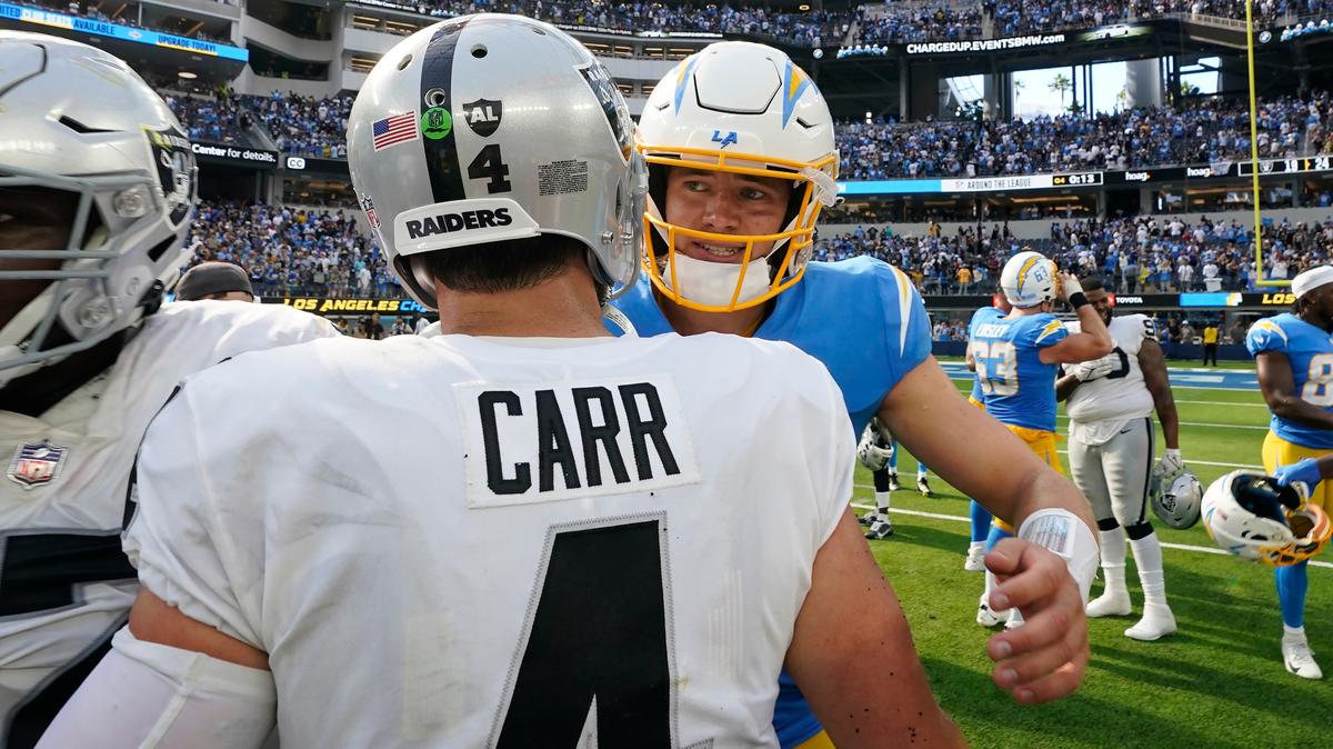 Las Vegas Raiders quarterback Derek Carr (4) greets Los Angeles Chargers quarterback Justin Herbert after an NFL football game in Inglewood, Calif., Sunday, Sept. 11, 2022. (AP Photo/Gregory Bull)