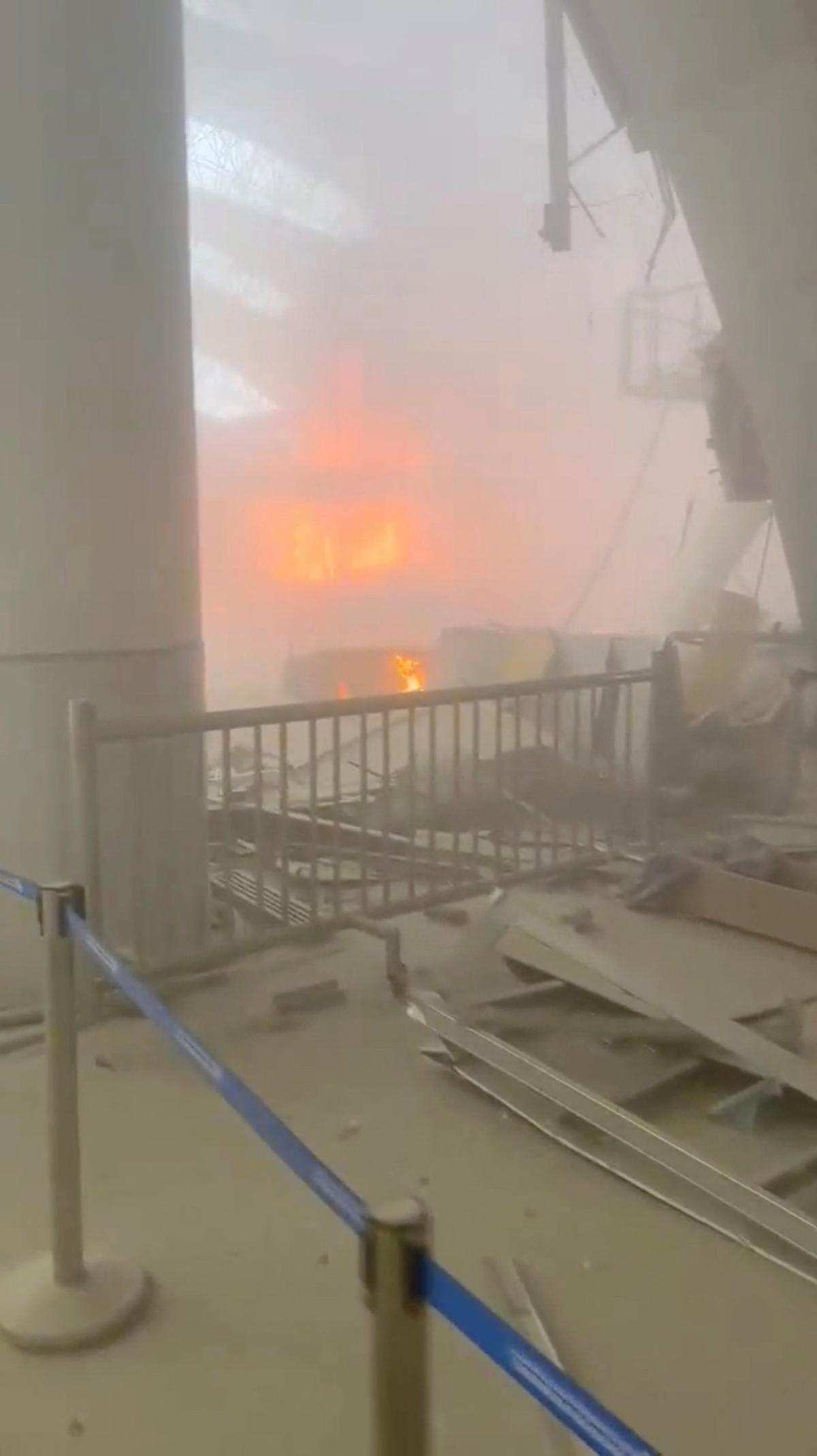 Debris lies on the floor as fire burns in the background, in the aftermath of Iranian strikes, according to the foreign ministry, at Kuwait International Airport in Kuwait City, Kuwait, June 3, 2026, in this still image obtained from a social media video.  Social Media/via REUTERS