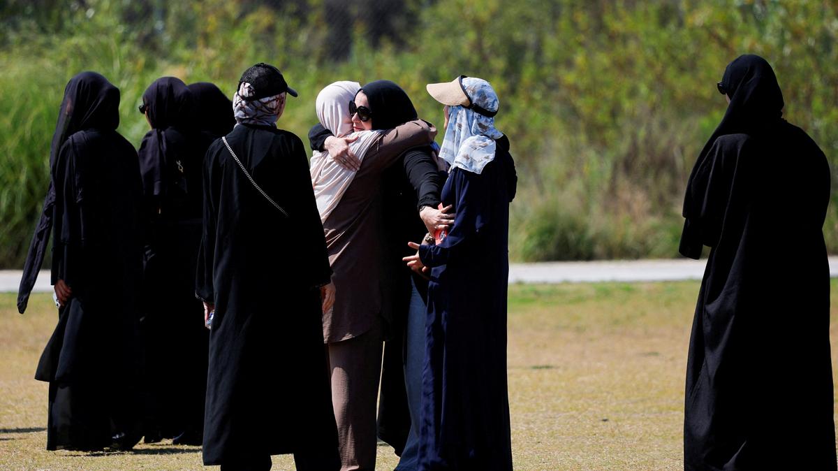 People embrace as they arrive at a prayer service for the victims of a shooting at the Islamic Centre, in San Diego, California, U.S., May 21, 2026.  REUTERS/Mike Blake