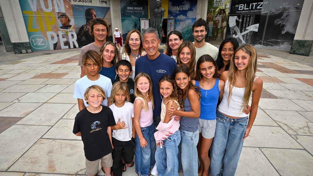 Aaron Pai with his wife, Sher, and their 10 grandchildren and three of their four children outside Huntington Surf and Sport in Huntington Beach, CA, on Wednesday, June 17, 2026. Aaron Pai has been running the surf store since 1978. (Photo by Jeff Gritchen, Orange County Register/SCNG)