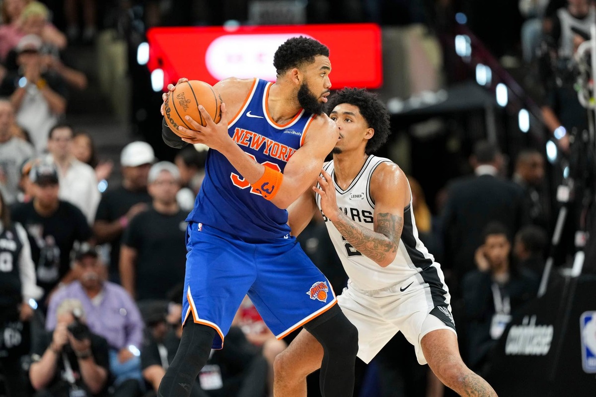  New York Knicks center Karl-Anthony Towns looks to move the ball against the San Antonio Spurs during the 2026 NBA Finals at Frost Bank Center. Scott Wachter-Imagn Images