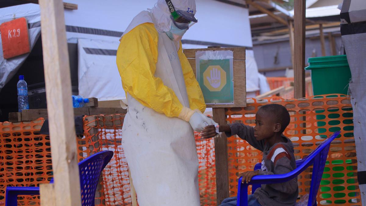 An Ebola nurse at the CTE ALIMA BENI Ebola Treatment Center cares for a child suspected of having Ebola. (Kitsa Musayi/dpa/TNS)