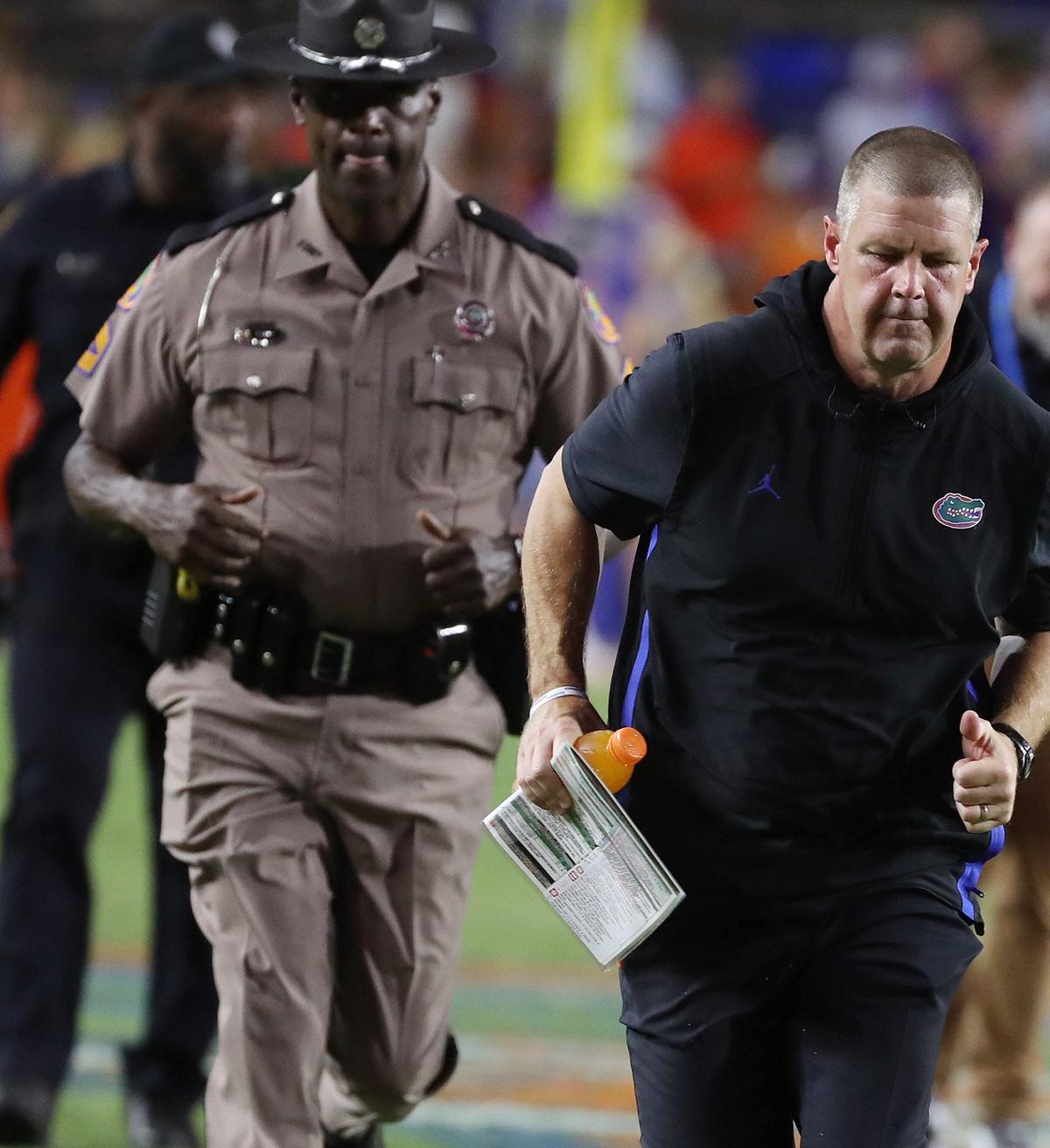 University of Florida head coach Billy Napier hangs his head as he runs off the field after losing the USF at UF college football game at Ben Hill Griffin Stadium in Gainesville on Saturday, September 6, 2025. USF won the game 18-16. (Stephen M. Dowell/Orlando Sentinel)