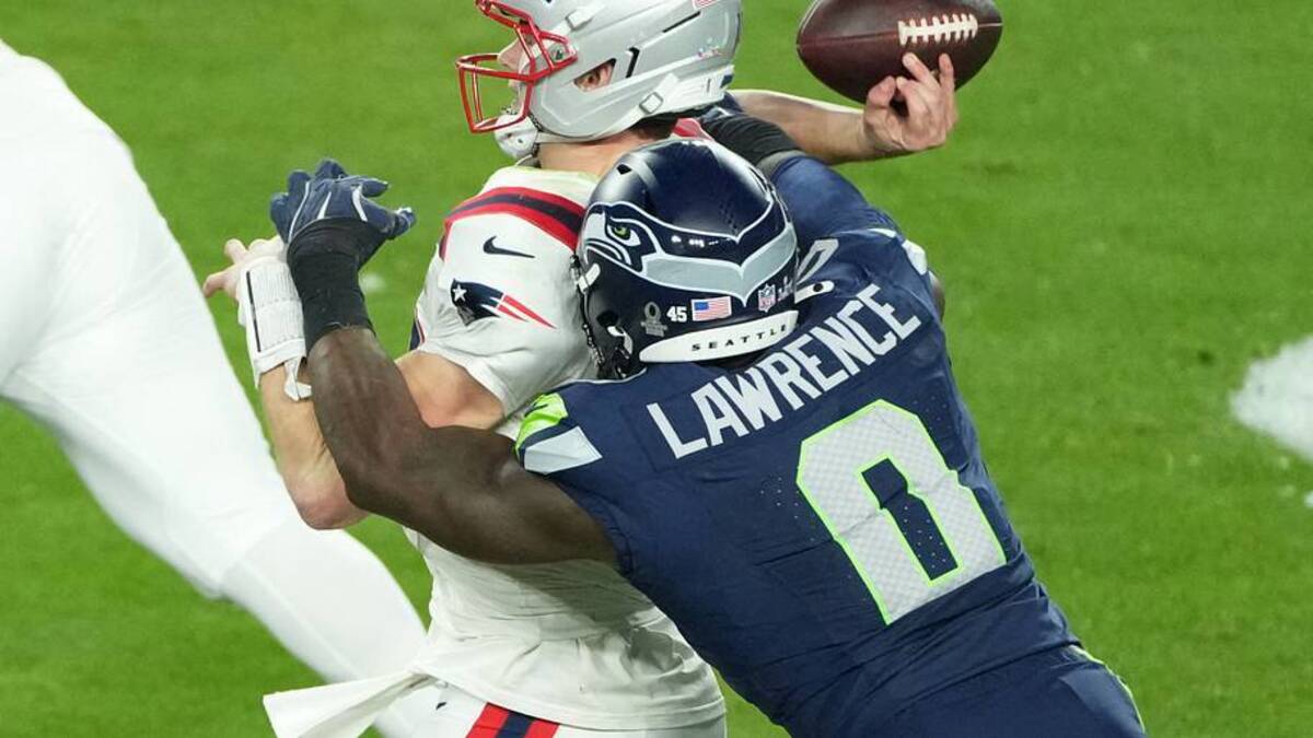 Feb 8, 2026; Santa Clara, CA, USA; New England Patriots quarterback Drake Maye (10) is hit as he throws by Seattle Seahawks defensive end DeMarcus Lawrence (0) in the second half in Super Bowl LX at Levi's Stadium. Mandatory Credit: Kirby Lee-Imagn Images | IMAGN IMAGES via Reuters Connect 
