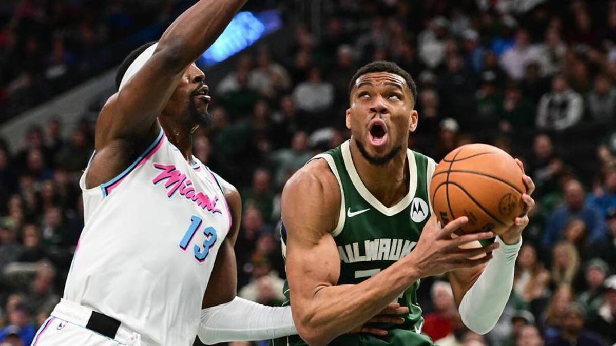  Jan 23, 2025; Milwaukee, Wisconsin, USA; Milwaukee Bucks forward Giannis Antetokounmpo (34) takes a shot against Miami Heat center Bam Adebayo (13) in the second quarter at Fiserv Forum. Mandatory Credit: Benny Sieu-Imagn Images | Benny Sieu-Imagn Images 