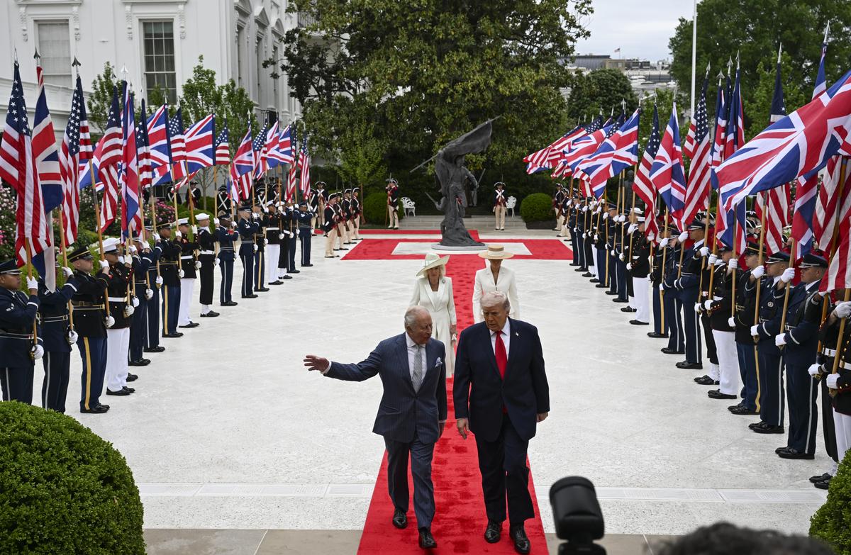 President Donald Trump, right, and King Charles III walk in front of first lady Melania Trump, rear right, and Queen Camilla through the Rose Garden during an arrival ceremony at the White House in Washington, on Tuesday, April 28, 2026. (Kenny Holston/The New York Times)