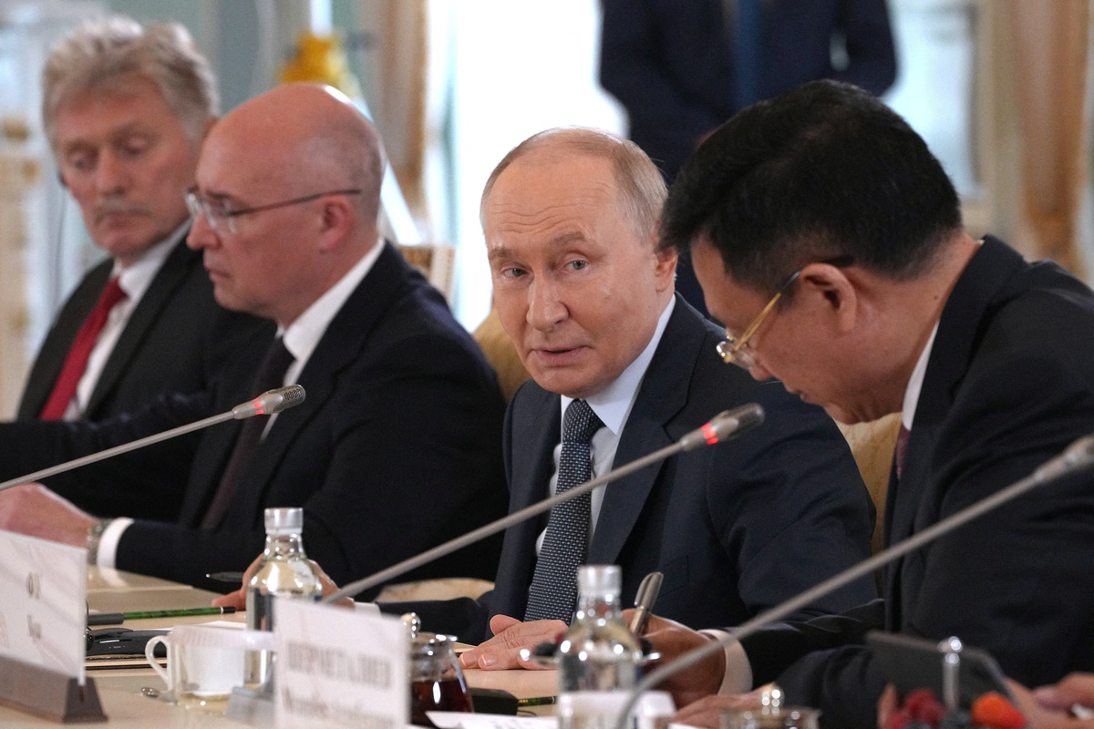 Russian President Vladimir Putin speaks with Fu Hua, president of Chinese news agency Xinhua, during a meeting with representatives of international news agencies as Director General of the Russian News Agency TASS, Andrey Kondrashov, and and Kremlin spokesman Dmitry Peskov sit near, on the sidelines of the St. Petersburg International Economic Forum, at the Constantine Palace in St. Petersburg, Russia, June 4, 2026.  Dmitri Lovetsky/Pool via REUTERS