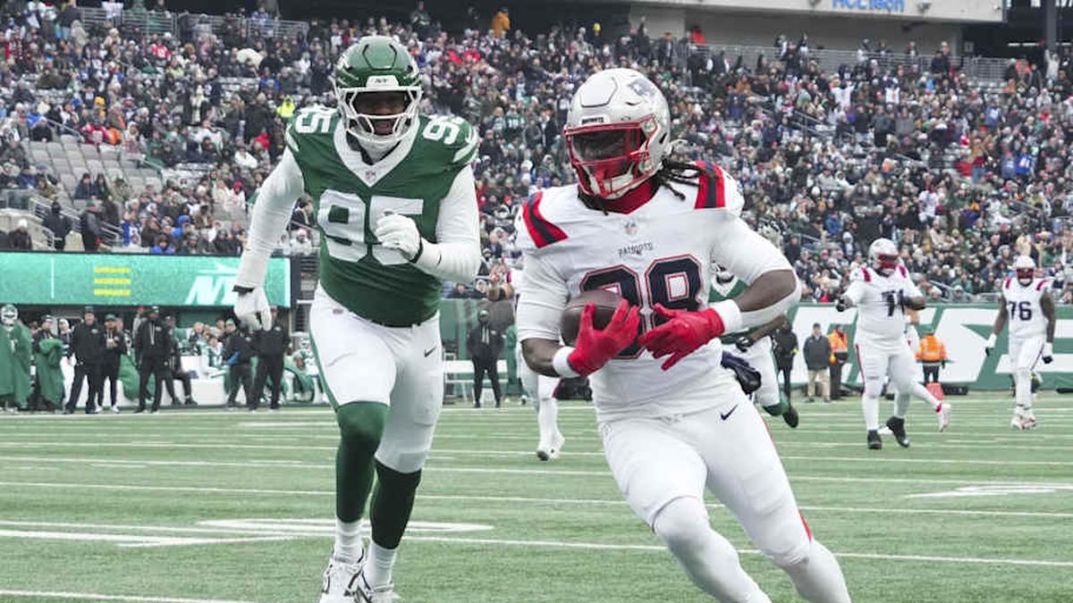  Dec 28, 2025; East Rutherford, New Jersey, USA; New England Patriots running back Rhamondre Stevenson (38) with a touchdown reception against New York Jets defensive end Eric Watts (95) during the second quarter of the game at MetLife Stadium. Mandatory Credit: Robert Deutsch-Imagn Images | Robert Deutsch-Imagn Images 