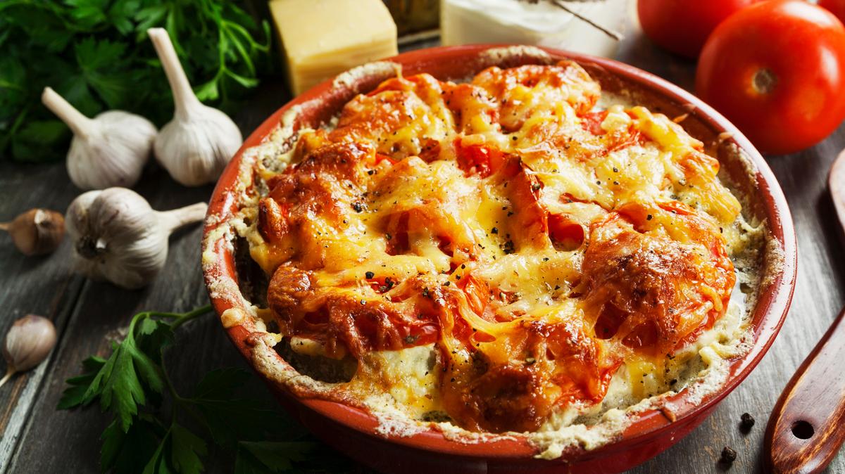 Fish casserole with tomatoes, sour cream and cheese