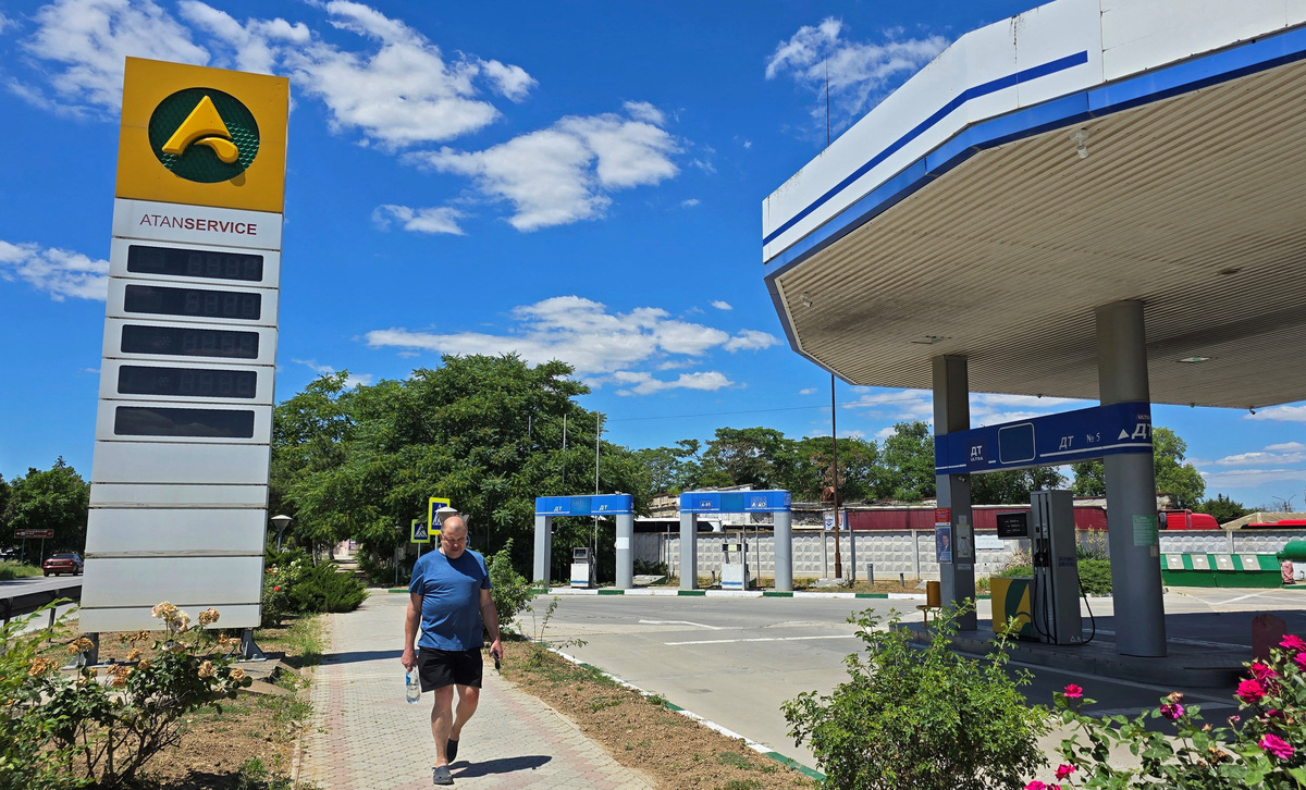 A man walks past an empty gas station after local authorities suspended petrol sales to the public and businesses due to a fuel crisis caused by Ukrainian attacks on its supply routes, in Yevpatoriya, Crimea, June 22, 2026. Picture taken with a mobile phone. REUTERS/Alexey Pavlishak
