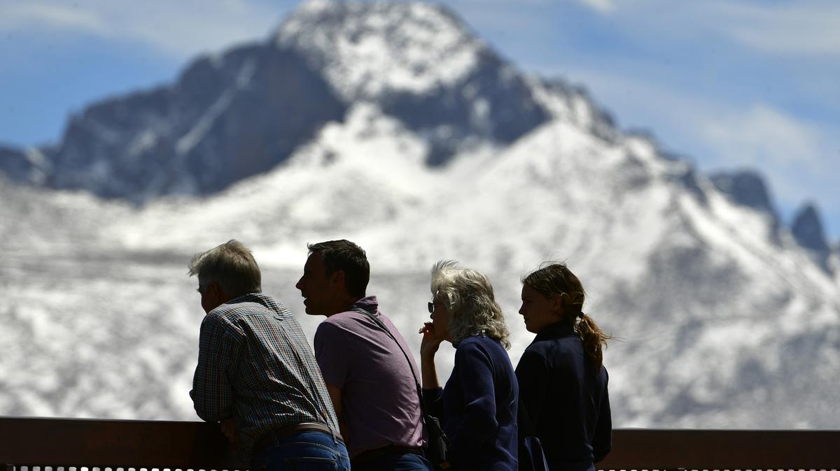 Rocky Mountain National Park visitors enjoy the views of Longs Peak and other well known peaks at Many Parks Curve Overlook along Trail Ridge Road in Rocky Mountain National Park on May 11, 2022, near Estes Park, Colorado. (Helen H. Richardson/The Denver Post/TNS)