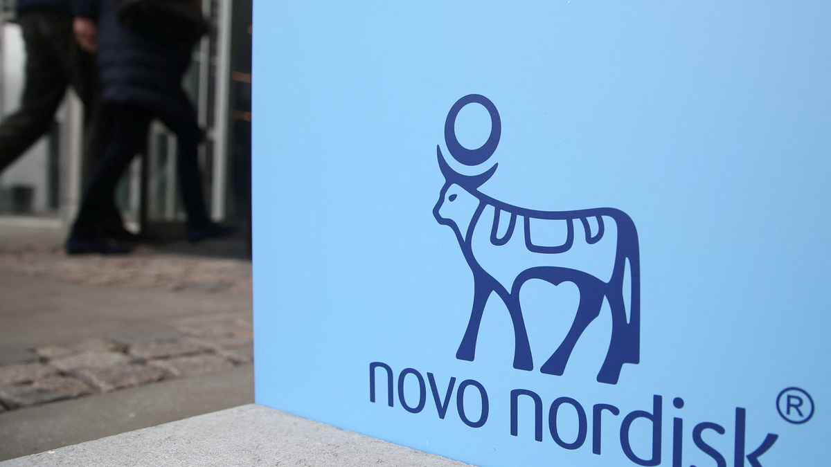People walk past a sign for Novo Nordisk’s annual general meeting at the entrance to the venue in Copenhagen, Denmark,  March 26, 2026. REUTERS/Tom Little