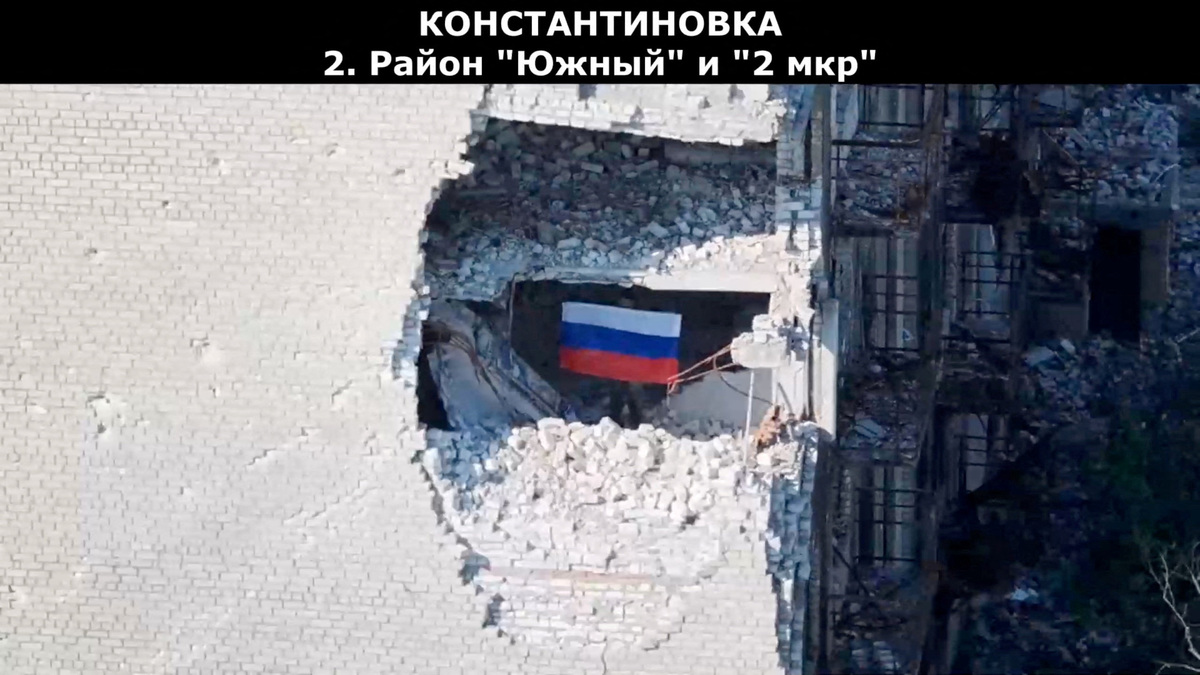 A drone view shows a soldier holding up a Russian flag, as the Russian defence ministry says its forces had taken control of Kostiantynivka, in the course of the Russia-Ukraine conflict, in the Donetsk region, Ukraine in this screen grab from handout video released July 3, 2026. Russian Defence Ministry/Handout via REUTERS
