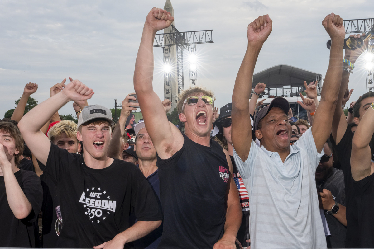 Attendees react during "UFC Freedom 250," a UFC event hosted by President Donald Trump for his 80th birthday, at the Ellipse, a park near the South Lawn of the White House in Washington, on Sunday, June 14, 2026. People from all over the country came to Washington on Sunday for a unique viewing party of the Ultimate Fighting Championship bouts being held on the South Lawn of the White House. (Alex Kent/The New York Times)