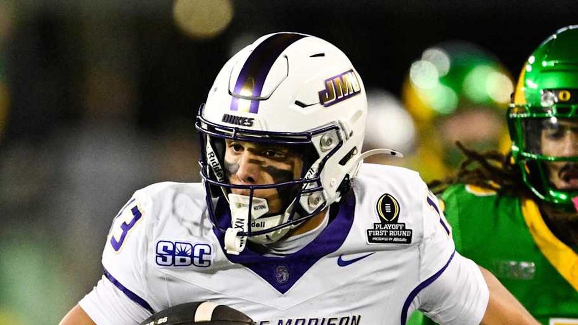  Dec 20, 2025; Eugene, OR, USA; James Madison Dukes wide receiver Landon Ellis (13) runs after making a catch as Oregon Ducks defensive back Theran Johnson (5) defends during the second quarter at Autzen Stadium. Mandatory Credit: Troy Wayrynen-Imagn Images | Troy Wayrynen-Imagn Images 