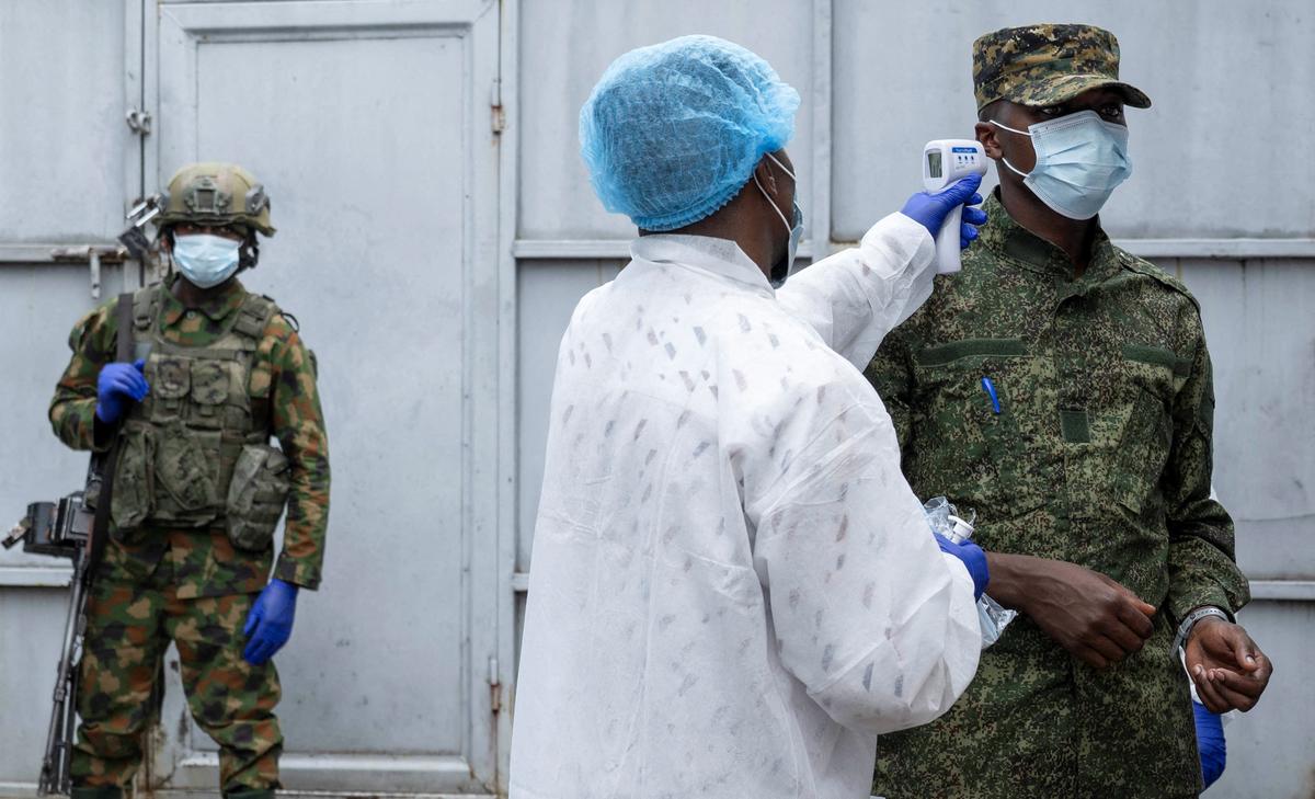 A health worker takes the temperature of an M23 rebel outside the laboratory where samples from suspected Ebola cases are examined, in Goma, Democratic Republic of Congo, May 19.  REUTERS/Arlette Bashizi