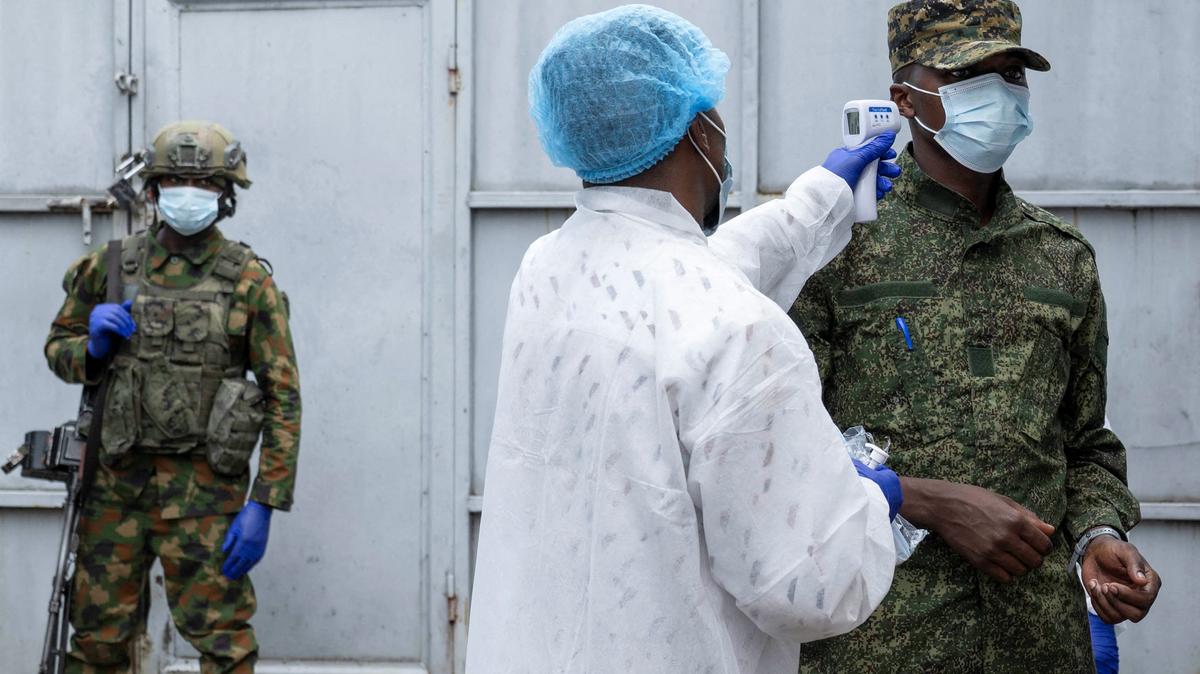A health worker takes the temperature of an M23 rebel outside the laboratory where samples from suspected Ebola cases are examined, in Goma, Democratic Republic of Congo, May 19.  REUTERS/Arlette Bashizi