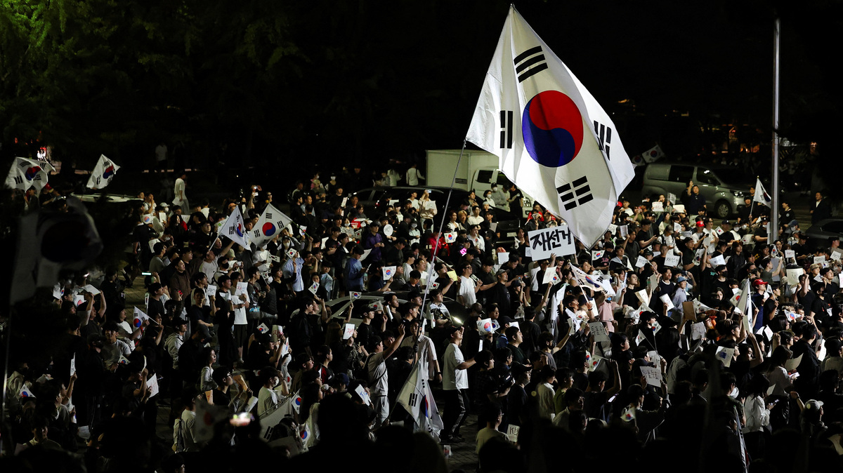A large South Korean flags flies over protesters as they surround a vote-counting centre to protest a controversy over a shortage of ballot papers that disrupted voting in the local election and to call for a rerun of the election, in Seoul, South Korea, June 6, 2026. REUTERS/Kim Hong-Ji