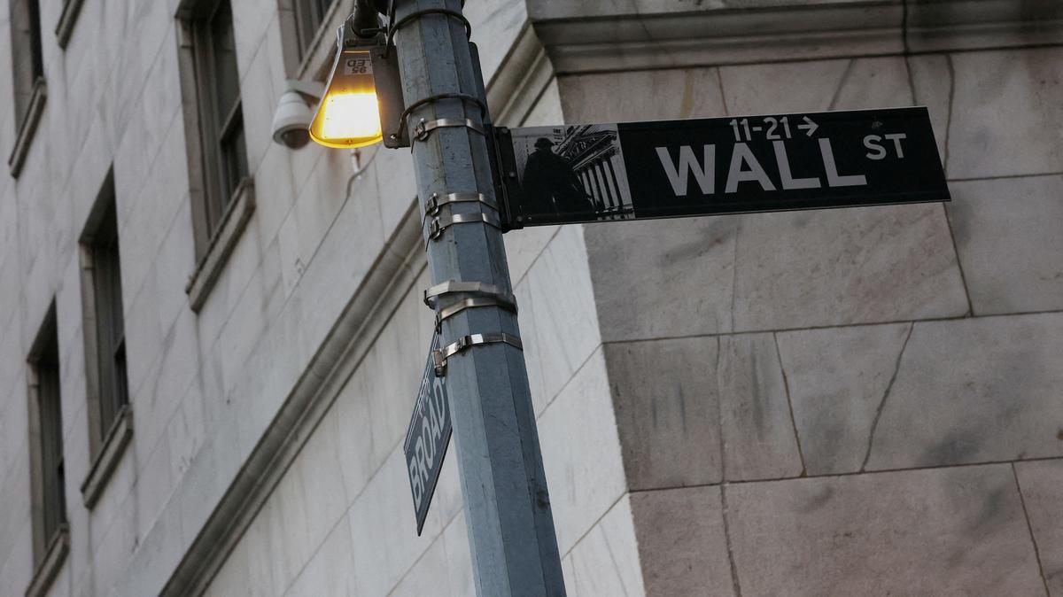 FILE PHOTO: The Wall street sign hangs outside the New York Stock Exchange (NYSE) building on Tuesday following Monday?s broad sell off in New York City, U.S., March 11, 2025. REUTERS/Shannon Stapleton/File Photo