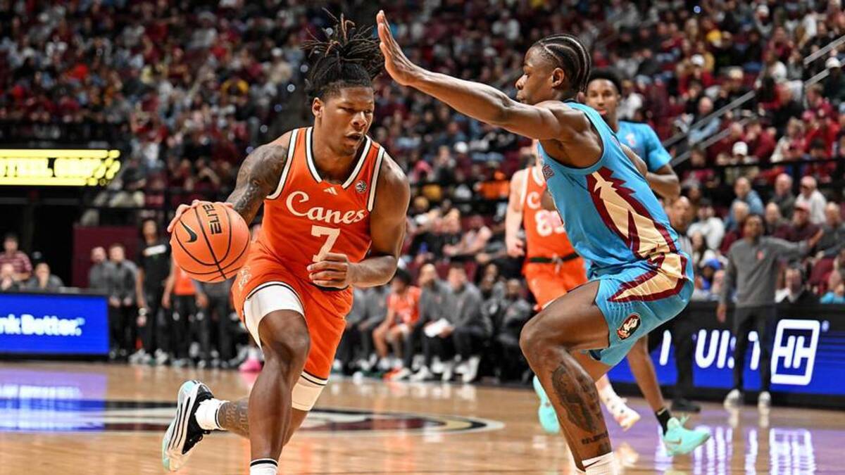  Feb 24, 2026; Tallahassee, Florida, USA; Miami Hurricanes forward Shelton Henderson (7) drives to the net past Florida State Seminoles forward Thomas Bassong (3) during the first half at Donald L. Tucker Center. Mandatory Credit: Melina Myers-Imagn Images | Melina Myers-Imagn Images 