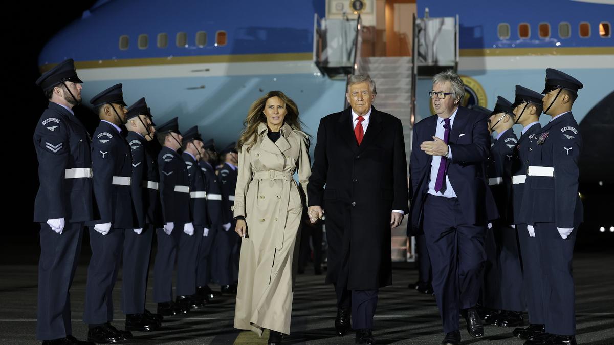 U.S. President Donald Trump and First Lady Melania Trump disembark Air Force One after arriving in London Tuesday.