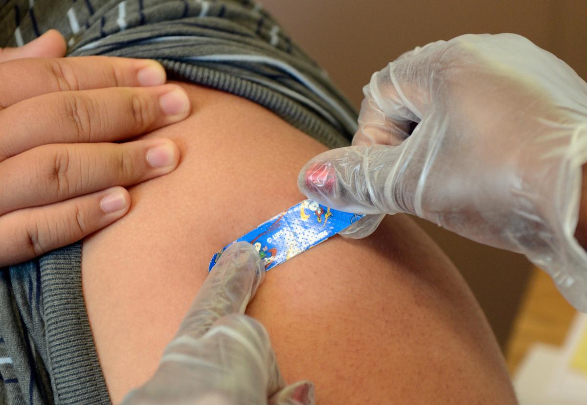 A student receives a vaccine against whooping cough, also called Tdap. (Kevork Djansezian/Getty Images/TNS)