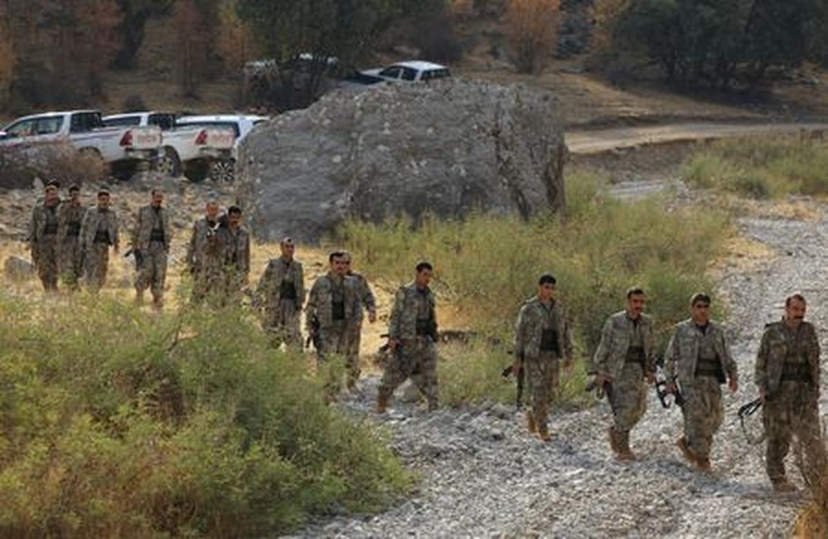 FILE PHOTO: Fighters with the Kurdistan Workers' Party (PKK) walk for a disarmament ceremony marking a significant step toward ending the decades-long conflict between Turkey and the outlawed group in the Qandil mountains, Iraq October 26, 2025. REUTERS/Thaier Al-Sudani/File Photo
