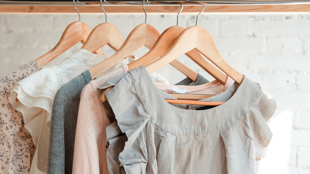 Female clothes on clothing rack. Pastel colors