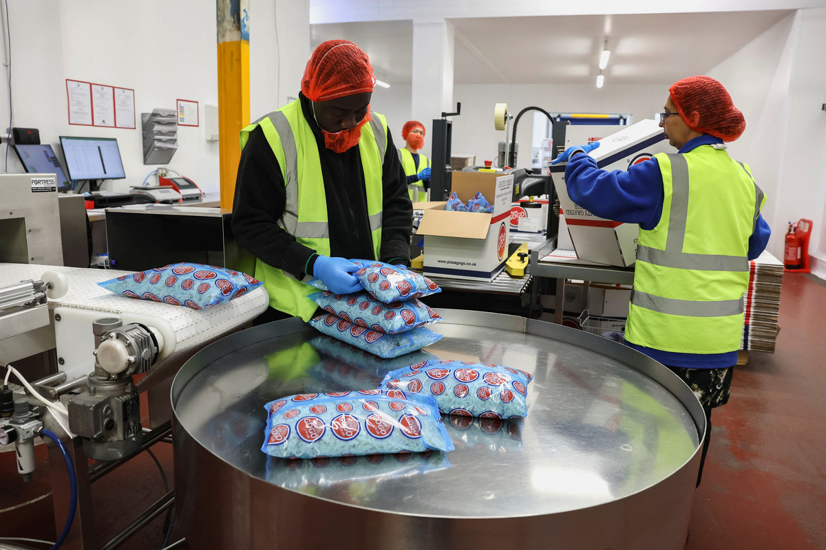 Workers package cheese products at the Bridge Cheese factory in Telford, Britain, June 10, 2026. REUTERS/Temilade Adelaja