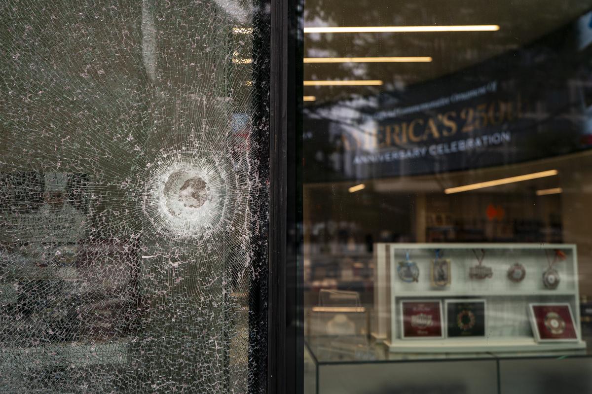  A shattered window of The People’s House: A White House Experience, after the weekend shooting near the White House in Washington, D.C. 