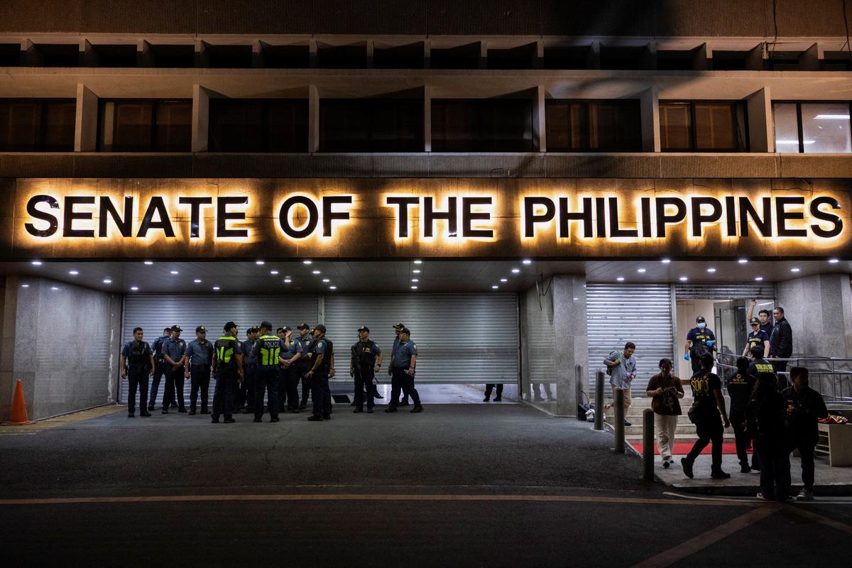 Police officers stand outside the Senate building, after gunshots were heard at the Philippine Senate, as chaos mounted in anticipation of an attempt to arrest a top senator wanted by the International Criminal Court, in Pasay City, Metro Manila, Philippines, May 13, 2026. REUTERS/Eloisa Lopez