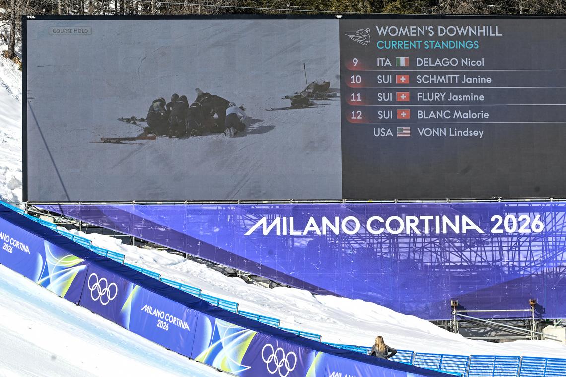  A giant screen shows US' Lindsey Vonn receiving assistance after a crash in the women's downhill event during the Milano Cortina 2026 Winter Olympic Games at the Tofane Alpine Skiing Centre in Cortina d'Ampezzo on February 8, 2026.Tiziana FABI / AFP 