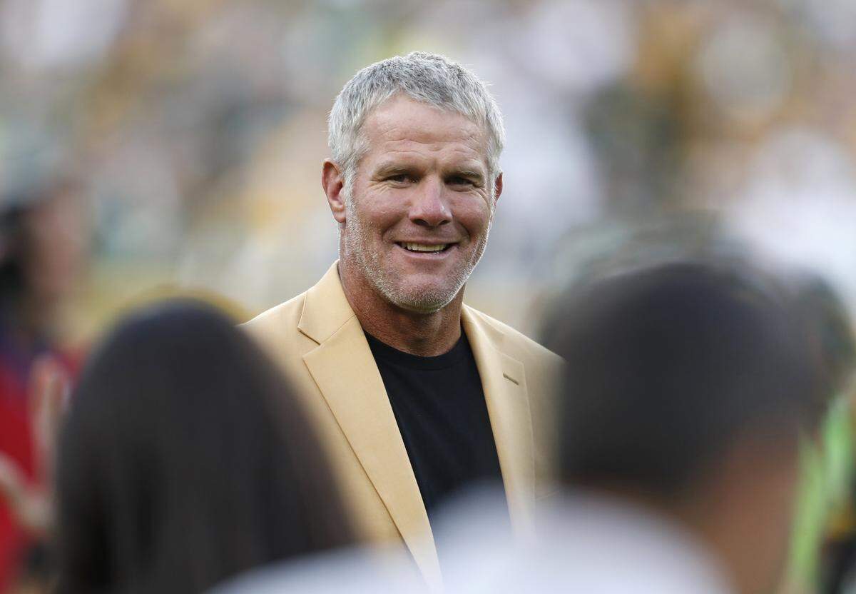 FILE - In this Oct. 16, 2016, file photo, Hall of Fame quarterback Brett Favre is shown during a halftime ceremony of an NFL football game against the Dallas Cowboys, in Green Bay, Wis. Favre says he made three trips to rehabilitation centers to fight his dependence on painkillers and alcohol. Sports Illustrated reports that Favre says he took as many as 14 Vicodin at one time during his MVP season of 1995. The former Green Bay Packers star said “that year, when I woke up in the morning, my first thought was, ‘I gotta get more pills.’ “