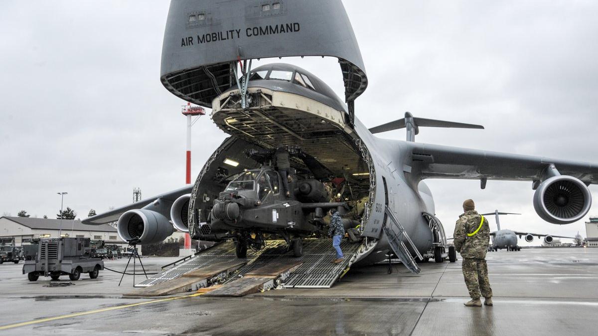 An U.S. Army helicopter is unloaded from an C-5M Galaxy at Ramstein Air Base, southwest of Frankfurt, amid NATO's Operation Atlantic Resolve in 2017. Home to around 27,000 troops and their families, "Little America" has been the headquarters for U.S. Air Forces in Europe and a critical NATO facility since 1952. File Photo courtesy U.S. Air Force/Staff Sgt. Timothy Moore
