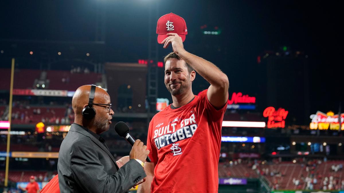 St. Louis Cardinals starting pitcher Adam Wainwright tips his cap while being interviewed after the Cardinals defeated the Milwaukee Brewers in a baseball game to clinch a playoff spot Tuesday, Sept. 28, 2021, in St. Louis. (AP Photo/Jeff Roberson)