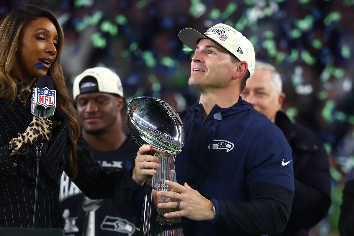  Feb 8, 2026; Santa Clara, CA, USA; Seattle Seahawks head coach Mike MacDonald celebrates with the Vince Lombardi trophy on the podium after defeating the New England Patriots in Super Bowl LX at Levi's Stadium. Mandatory Credit: Mark J. Rebilas-Imagn Images 