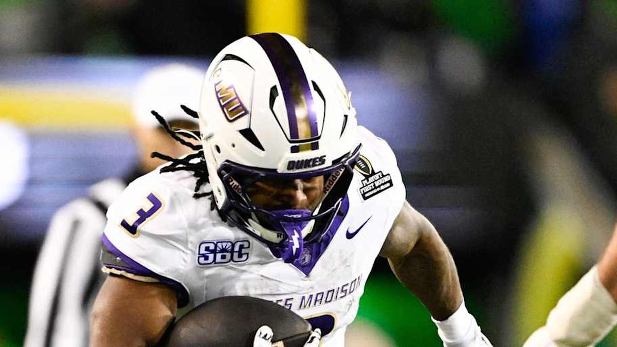  Dec 20, 2025; Eugene, OR, USA; James Madison Dukes running back Wayne Knight (3) rushes as Oregon Ducks defensive back Aaron Flowers (21) defends during the second quarter at Autzen Stadium. Mandatory Credit: Troy Wayrynen-Imagn Images | Troy Wayrynen-Imagn Images 