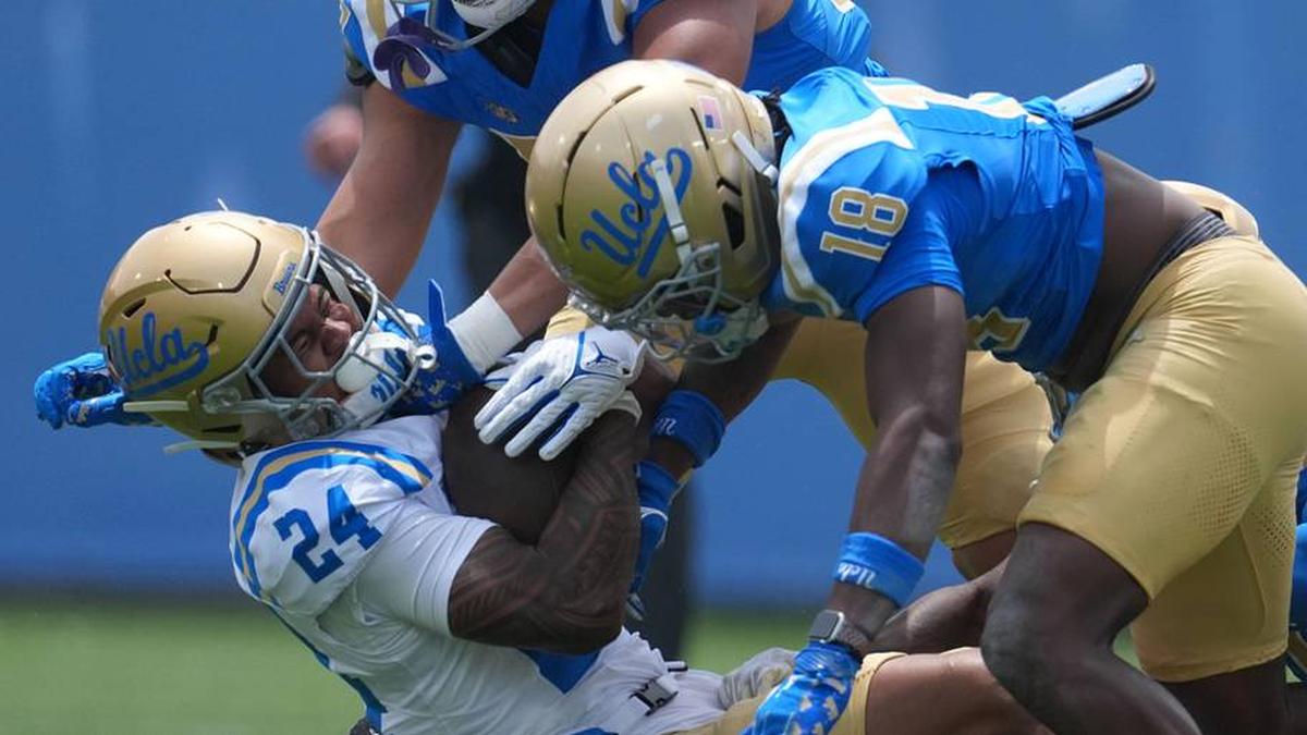  May 2, 2026; Pasadena, CA, USA; UCLA Bruins linebacker Matthew Muasau (57) and defensive backs Osiris Gilbert (18) and Cole Martin (4) tackle receiver Jonah Smith (24) during the spring game at Rose Bowl. Mandatory Credit: Kirby Lee-Imagn Images | Kirby Lee-Imagn Images 
