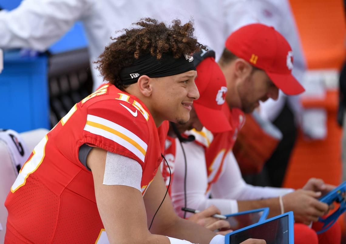  Kansas City Chiefs quarterback Patrick Mahomes (15) and quarterback Alex Smith (11) study tablets on the bench during the second half against the Buffalo Bills at Arrowhead Stadium in 2017. (Credit: Denny Medley-USA TODAY Sports) 
