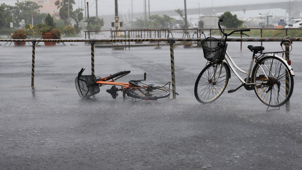 A bicycle falls on the ground in the heavy rain as Typhoon Bavi approaches in Ishigaki, Japan, July 10, 2026.  REUTERS/Kim Kyung-Hoon