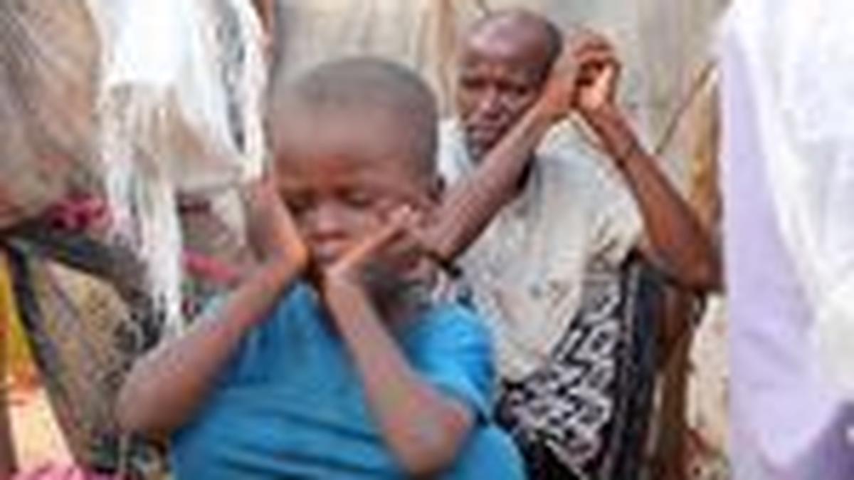 Internally displaced people sit outside their makeshift shelters during a visit by World Food Programme’s Assistant Executive Director for Programme Operations, Matthew Hollingworth (not in the photo), to assess the knock on effects from the escalation in the Middle East, alongside drought and sharp cuts in humanitarian funding that are worsening hunger, in Kahda district of Mogadishu, Somalia May 7, 2026. REUTERS/Feisal Omar