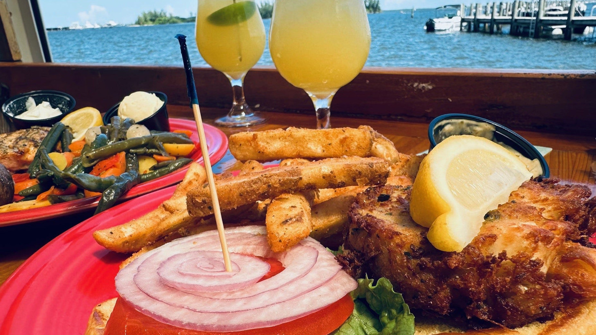 Crab cake sandwich and fries (salmon special in background) at Blackfins Riverfront Grill, Sebastian.