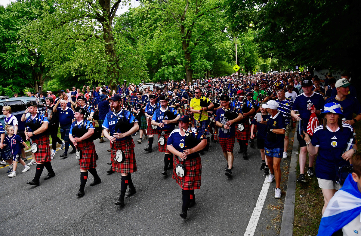 Soccer Football - FIFA World Cup 2026 - Scotland's Tartan Army march to Boston's Fenway Park baseball stadium - Boston, Massachusetts, U.S. - June 14, 2026 Scotland fans wearing kilts and playing the bagpipes during the march to Fenway Park IMAGN IMAGES via Reuters/Bob Dechiara